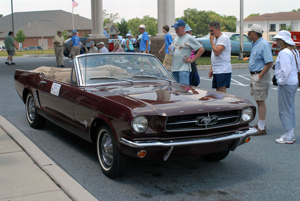 Car enthusiasts line up to view the 1965 Ford Mustang convertible, restored by Penn College students and returned for display at the Antique Automobile Club of America Museum in Hershey.