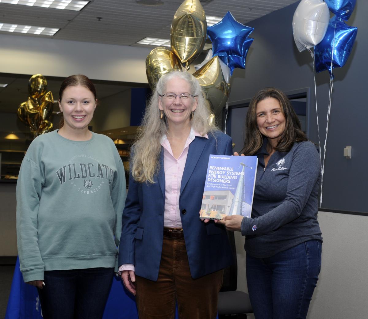 The author (center) is joined at her book-signing by two supportive members of Women in Construction: Amanda F. Ritter (left), enrolled in building science and sustainable design, and Sandra M. Gallick, an architecture and sustainable design student.